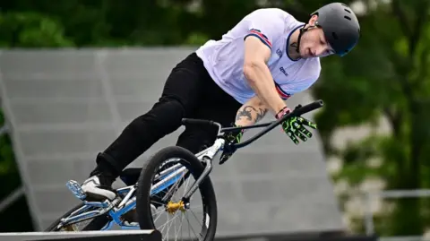 Reuters Jude Jones with black helmet and white top doing stunts on a BMX bike