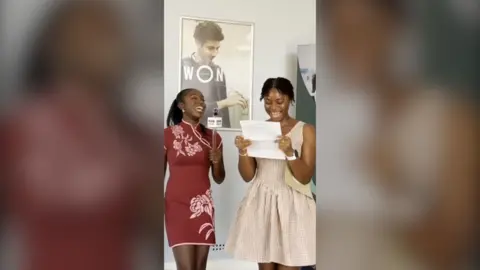 A T Level student celebrates after opening her results with a BBC journalist