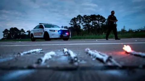 Getty Images A sheriff's deputy in Harris County, Texas, responds to a fire at a chemical plant