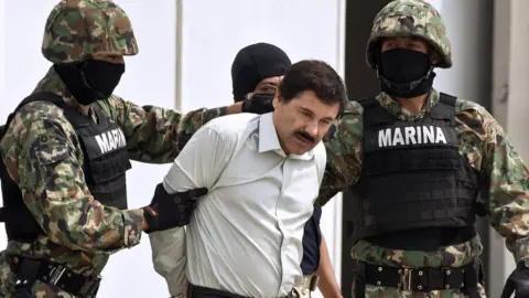 Getty Images Mexican drug trafficker "El Chapo" is escorted by marines after his arrest in 2014