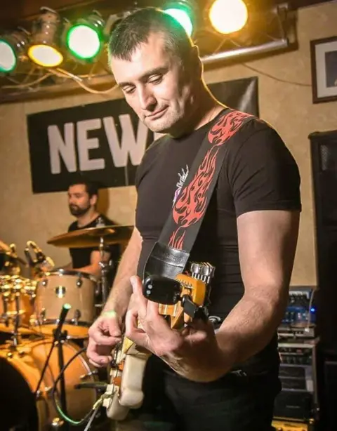 Artem playing guitar