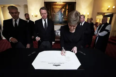 Kirsty O'Connor/Pool via REUTERS Scotland's First Minister Nicola Sturgeon signs the Proclamation of Accession