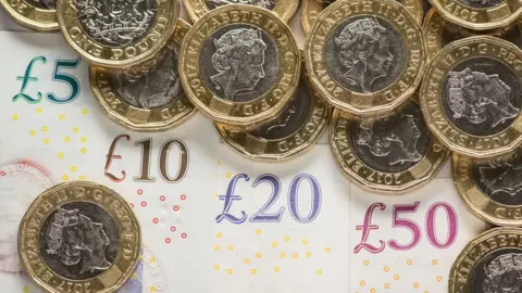 PA Media British pound coins and notes