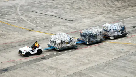 Getty Images Cargo being moved at an airport