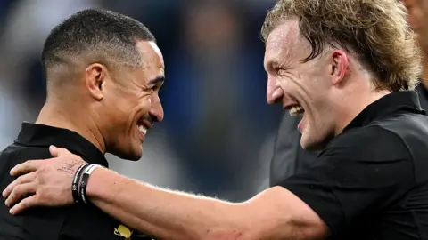 Aaron Smith and Damian MacKenzie celebrate beating Argentina