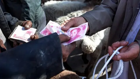 Getty Images Sheep traders swapping cash