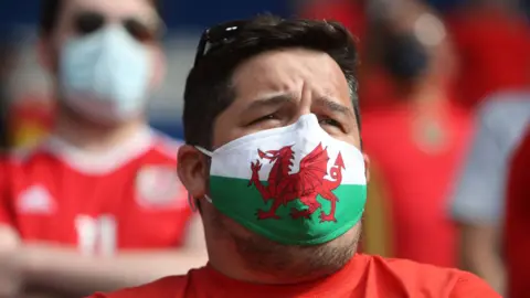 Getty Images Man wearing Welsh flag facemask