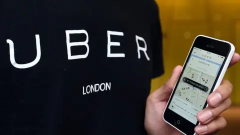 Getty Images Man using Uber app on a mobile phone