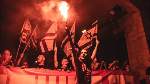 Getty Images People gather outside the Supreme Court to protest against Israeli Prime Minister Benjamin Netanyahu and the government's judicial overhaul, in Jerusalem, 11 September 2023