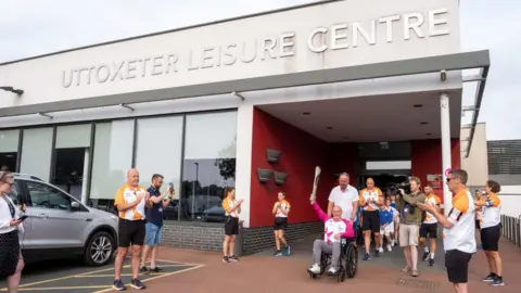 Getty Images Glyn Bennett takes part in The Queen's Baton Relay as it visits Uttoxeter as part of the Birmingham 2022 Queens Baton Relay on July 20, 2022 in Uttoxeter