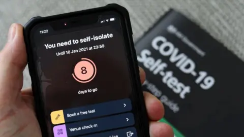 Getty Images The NHS Covid app shows a self isolate warning