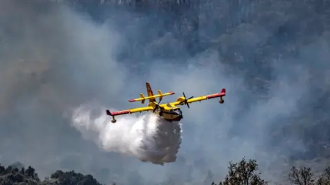 AFP Aircraft with plume of smoke behind it