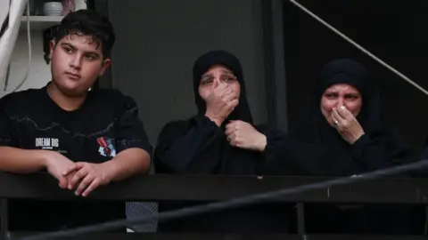 Reuters People mourn as they watch from a balcony during the funeral in Beirut, 18 Sept