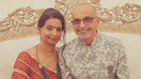 Jay Bapodra Two people are pictured close to each other, smiling.