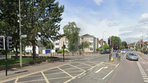 Iffley Road, near to the junction with Donnington Bridge Road. It is a busy single carriageway, yellow-box junction.