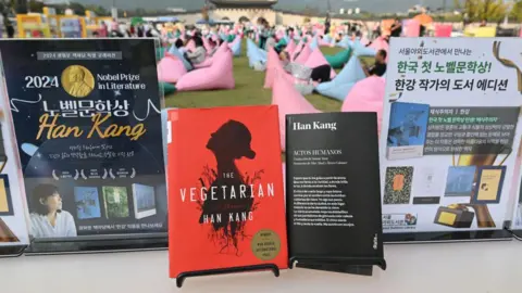 Getty Images Books by South Korean author Han Kang, who won the 2024 Nobel Prize in Literature, are displayed during an outdoor library event at Gwanghwamun square in central Seoul on October 11, 2024. 
