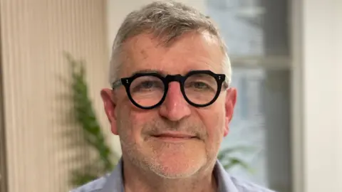 Head and shoulders image of the project director looking straight at the camera.