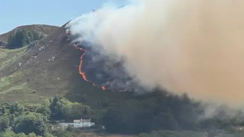 A large fire is seen on a mountainside