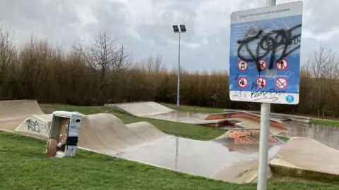 An empty skate park with graffiti