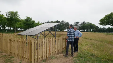 Jersey Electricity Image of James King, Solar PV Project Manager at Jersey Electricity and La Mare Wine Estate’s MD Tim Crowley at the demonstration site