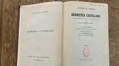 Cambridge University Library The inside pages of an old grammar book show the title and author, and the date it was acquired by the library - 1953.