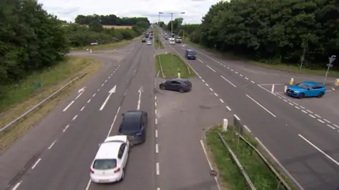 A white Seat and a blue Tesla collide in the outside lane of the A1 near  Great Ponton