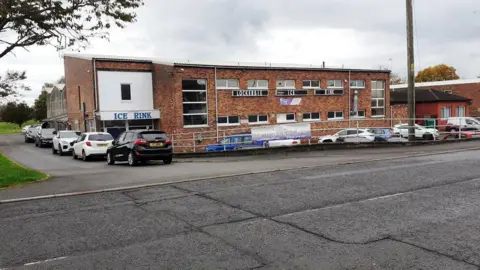 Luke Shaw An ice rink building in Lockerbie made predominantly of brick with a lot of cars parked around it