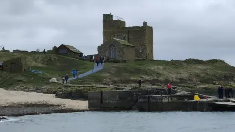 William Shiel  People walking up the path from the jetty on Inner Farne