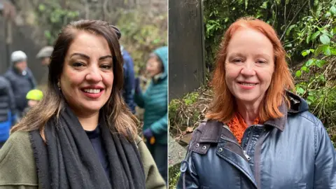 Side by side images of two women. On the left, Naz Shah wears a green jumper and black scarf. She has dark brown hair. Judith Cummins wears a navy waterproof jacket. She has ginger hair. Both of them are smiling at the camera.