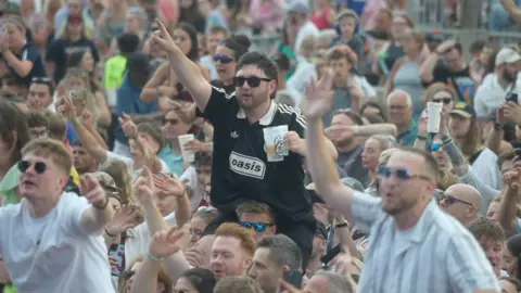 Jamie Niblock/ BBC Crowds at the Halo Festival, including some people on the shoulders of fellow festival goers
