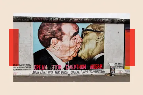 Getty Images A mural on the Berlin Wall showing Leonid Brezhnev and Erich Honecker kissing