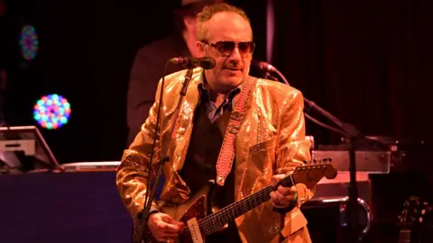 Lester Cohen/Getty Images Elvis Costello performing