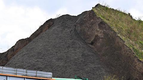 The mound of material on Simonswood Industrial Estate