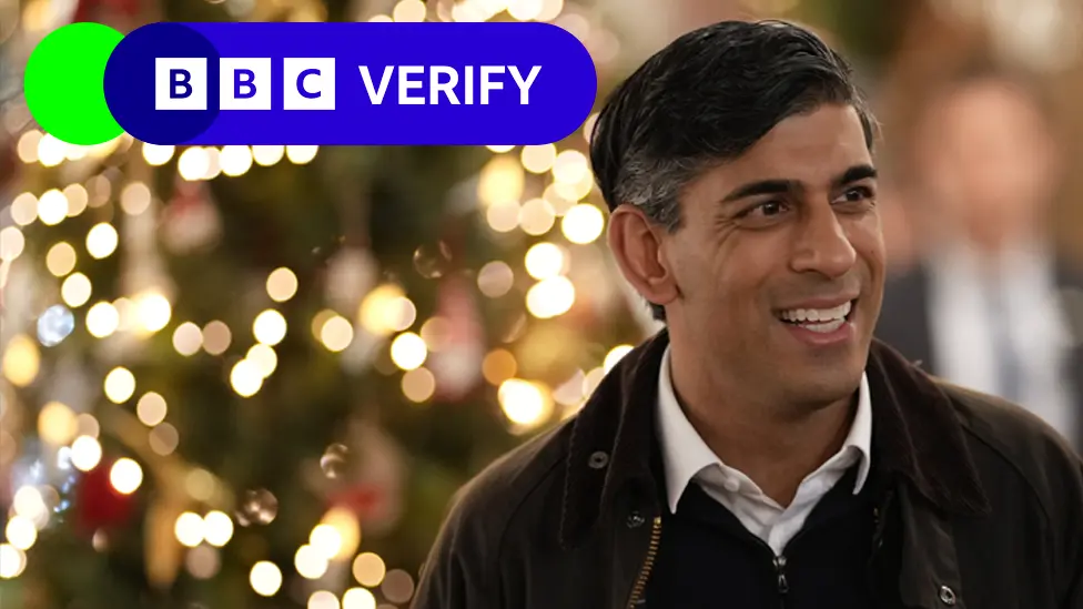 BBC Rishi Sunak with a Christmas tree in the background