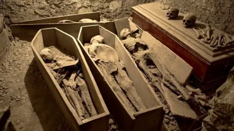 Geostock/Getty Images The vaults of the church contain many mummified remains