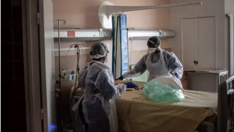 AFP Nurses clean a room at Saint-Louis hospital in Paris, on May 28, 2020