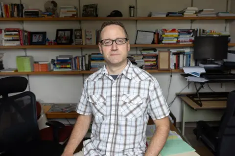 Scott Morgan Kedron Bardwell in his office