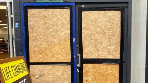 Yellow Submarine Wooden boards in the parts of a door previously filled with glass.