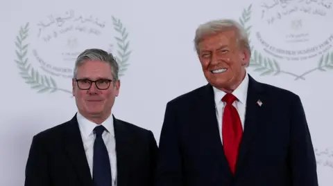 UK Prime Minister Sir Keir Starmer and US President Donald Trump stand alongside each other at a world leaders' summit on ending the Gaza war in October 2025.