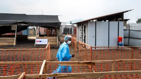 Glody Murhabazi Medic walking through a treatment centre