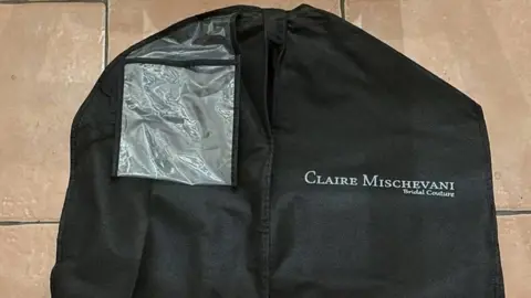 Met Police handout Image of a black garment bag with the designer's name printed on them.