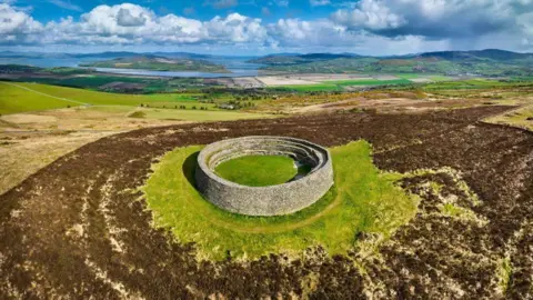 Getty Images Grianán of Aileach, a circualr stone fort on top of a hill.