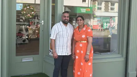 BBC Wales A couple stand outside a shop 