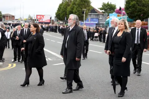 Pacemaker Sinn Féin's Mary Lou McDonald, Gerry Adams and Michelle O'Neill walking in the funeral cortege for Bobby Storey