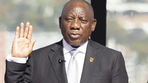 EPA South Africa's Cyril Ramaphosa takes the oath of office for his second term as South African President at the Union Buildings in Pretoria on June 19, 2024. 