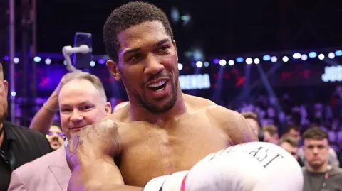 Anthony Joshua smiling after his win