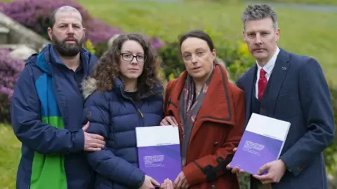 PA Media Colin and Kayleigh Griffiths, Rhiannon Davies and Richard Stanton with a copy of the Donna Ockenden Independent Review into Maternity Services