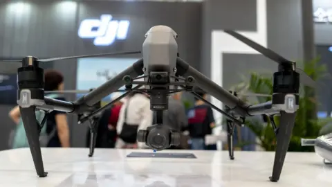 Getty Images Drones made by a Chinese company, DJI, are shown on a table