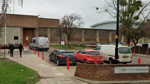 Google The entrance to HMP Chelmsford. In front of the prison building is a car park.