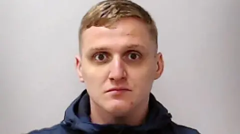 Scottish Police mug shot of Gavin Coull, who has blonde hair, a blue hoodie and dark circles under his eyes